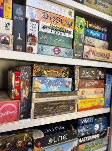 Several shelves containing a variety of tabletop games.